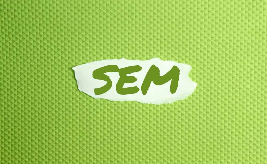 a torn paper written with inscription SEM on a green background