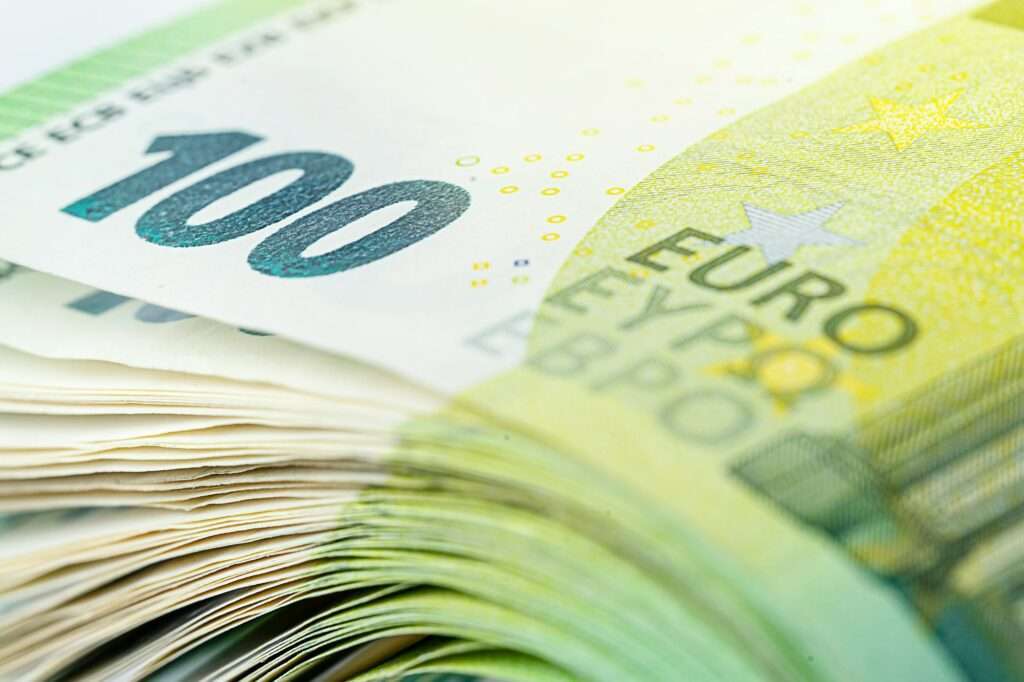One hundred euro bill. Stack of European currency