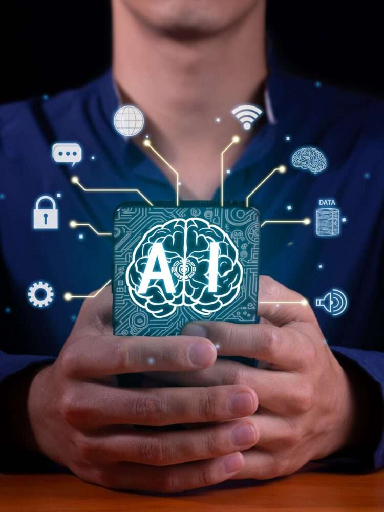 Webdesign Hannover - Eine Person hält ein Tablet mit einem digitalen Gehirn mit der Aufschrift „KI“ und verschiedenen damit verbundenen Technologie- und Datensymbolen, die Chatbot-Anwendungen für künstliche Intelligenz und die Zukunft der KI-Chat-Technologie darstellen. Local SEO Agentur Hannover.